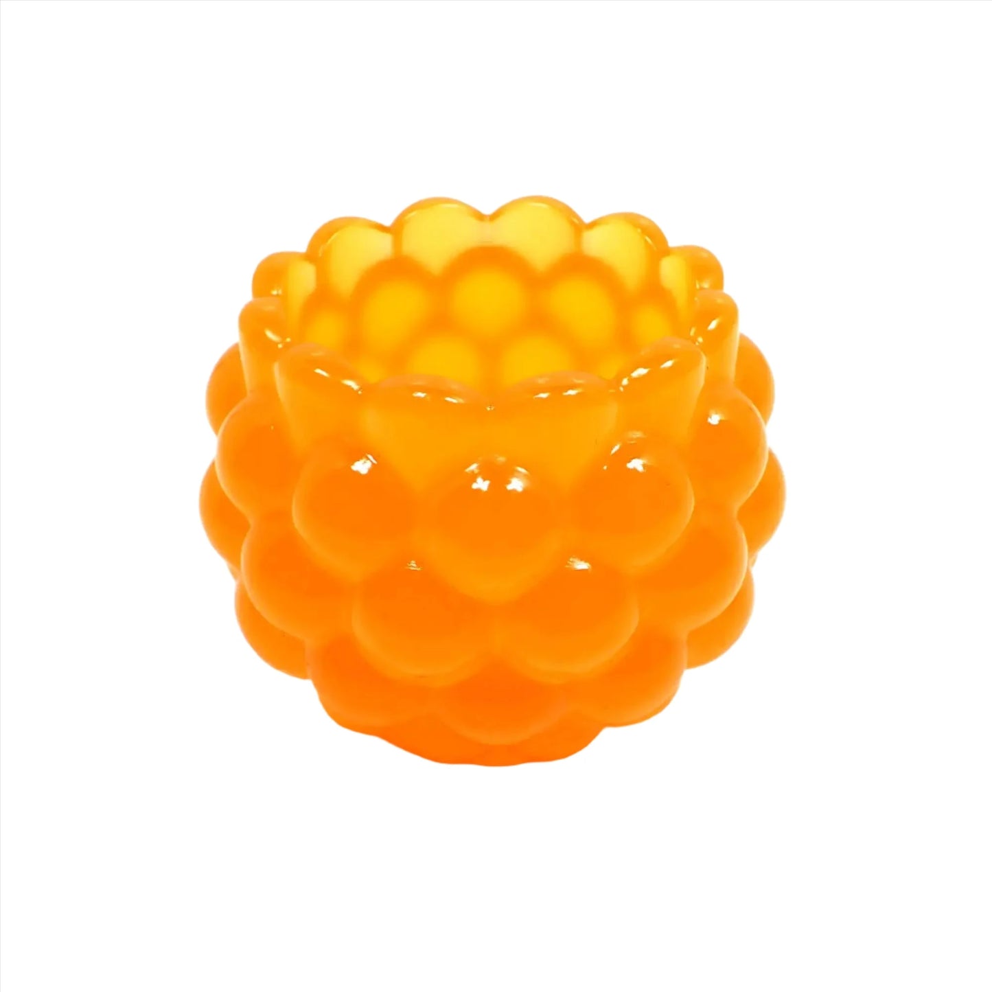 Side view of the handmade resin decorative bowl. The resin is bright neon tangerine orange in color. It has a rounded shape with a bumpy round ball textured on the outside. The top tapers slightly and has a scalloped edge.