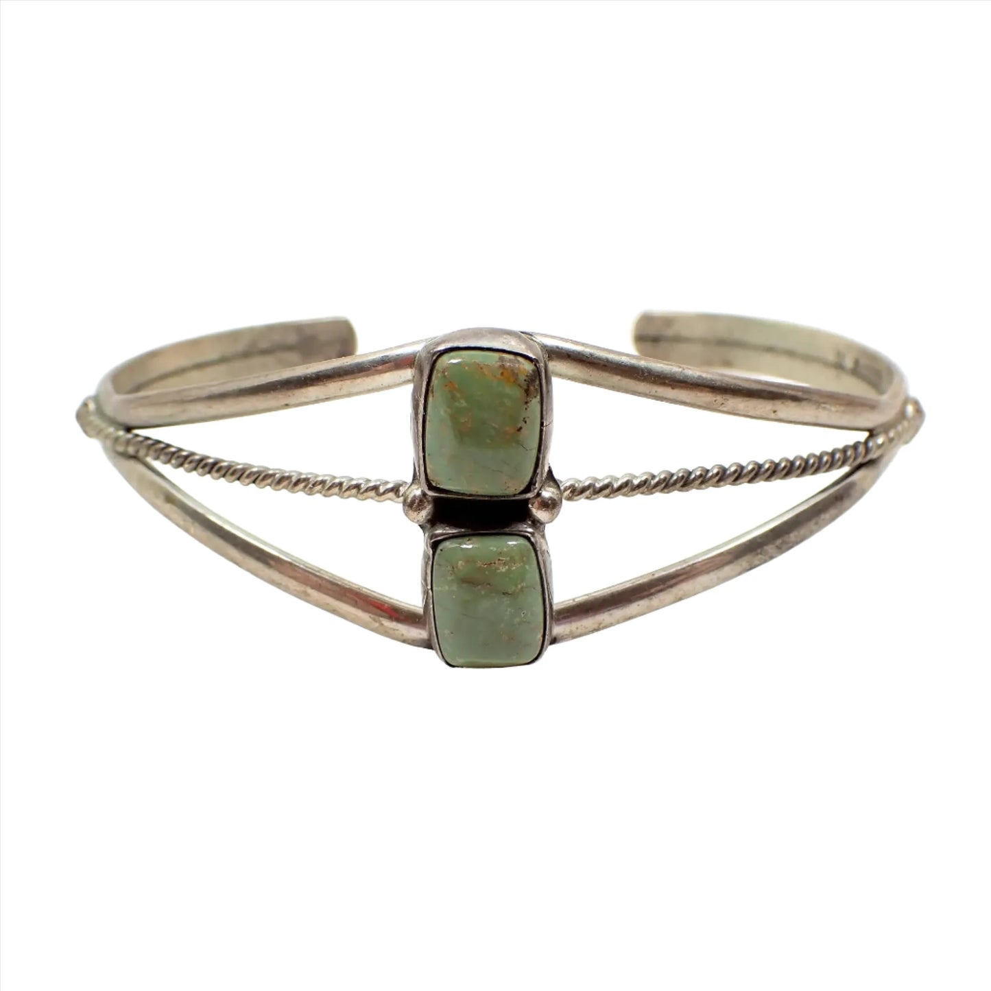 Front view of the retro vintage Wayne Estitty Navajo sterling silver and green turquoise cuff bracelet. it has an open curved design with a twisted curved wire in the middle. There are two puffy rectangle green turquoise cabs on the front.