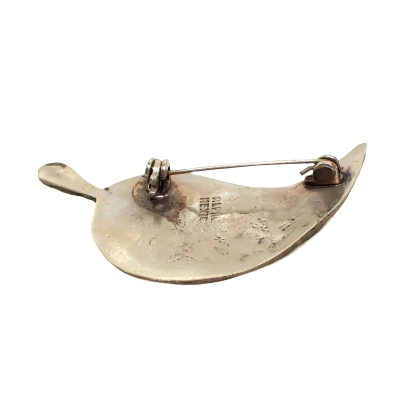 Photo showing the back of the brooch. The silver tone metal has darkened from age. The pin is slightly bent but holding in the clasp well. Part of the Alpaca Mexico marking can be seen.