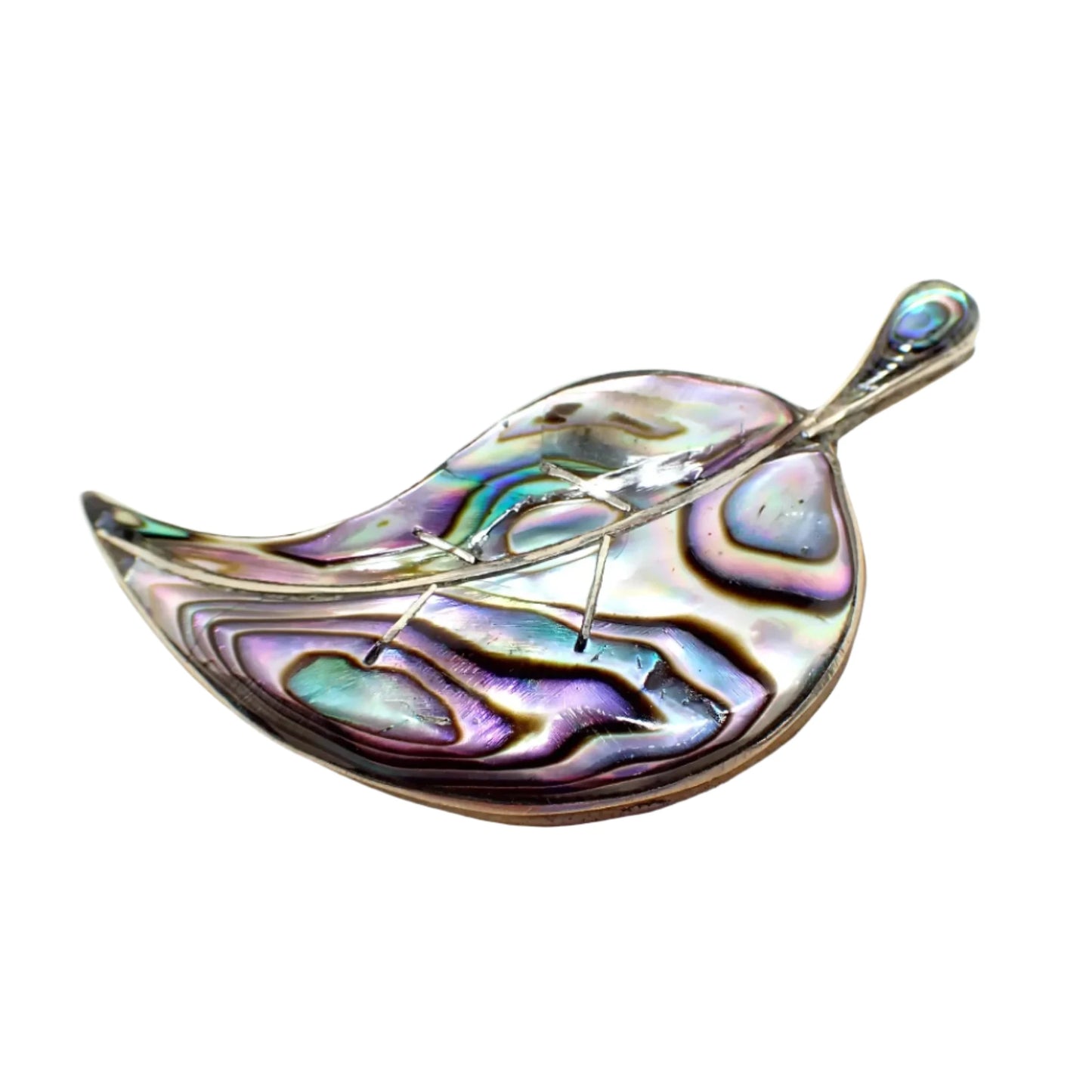 Enlarged front photo of the brooch showing the iridescent colors of the abalone shell. At the very tip of the leaf a chip out of the abalone and a small hairline crack can be seen.