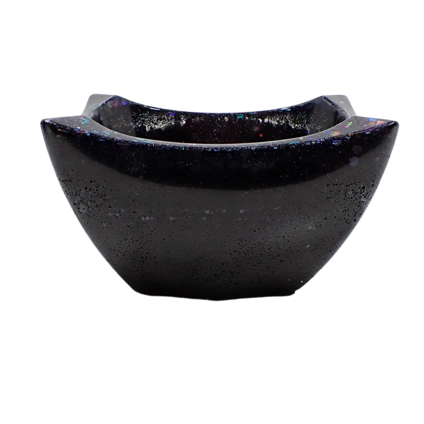 another side view of the black resin angled bowl with iridescent glitter. The pinched angled corners can be seen better in this view.