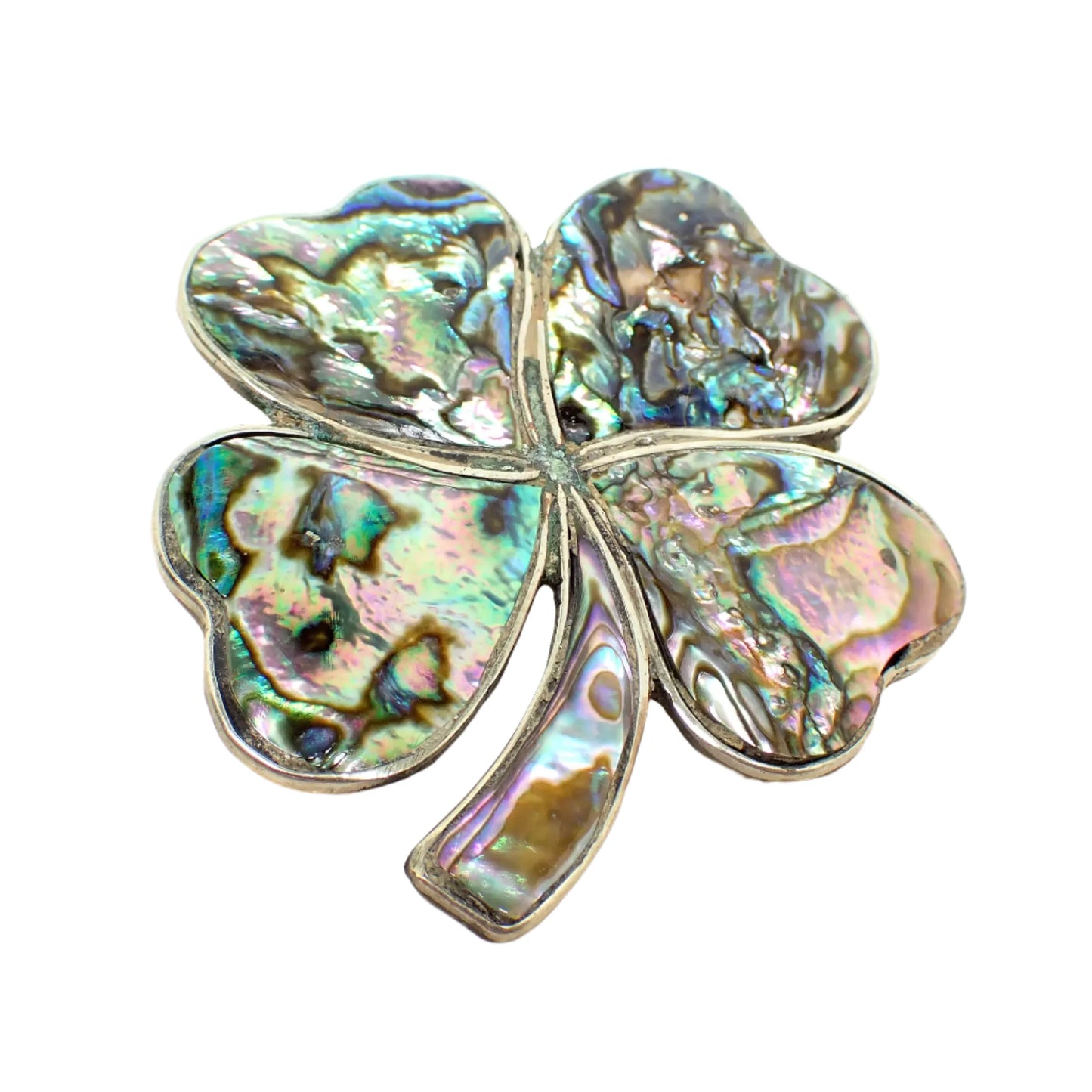 Front view of the retro vintage Alpaca four leaf clover brooch pin. The metal is silver tone in color. The leaves and stem have inlaid iridescent pieces of abalone shell.