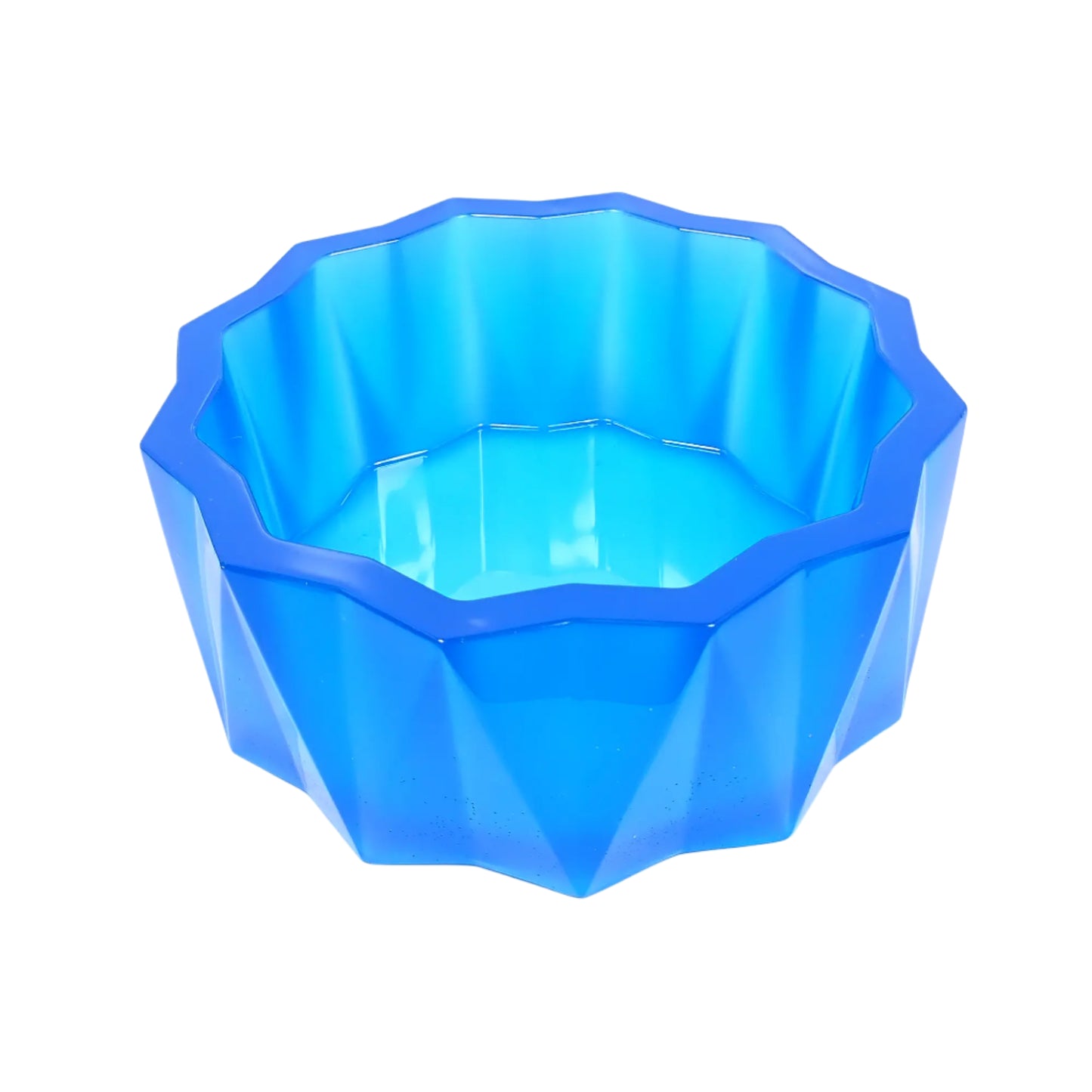 Angled side view of the large handmade neon blue resin faceted decorative bowl. It has a sun like faceted shape on top and a faceted triangle design on the sides with the triangles alternating in direction. The resin is shiny and semi translucent in a neon ocean blue color.