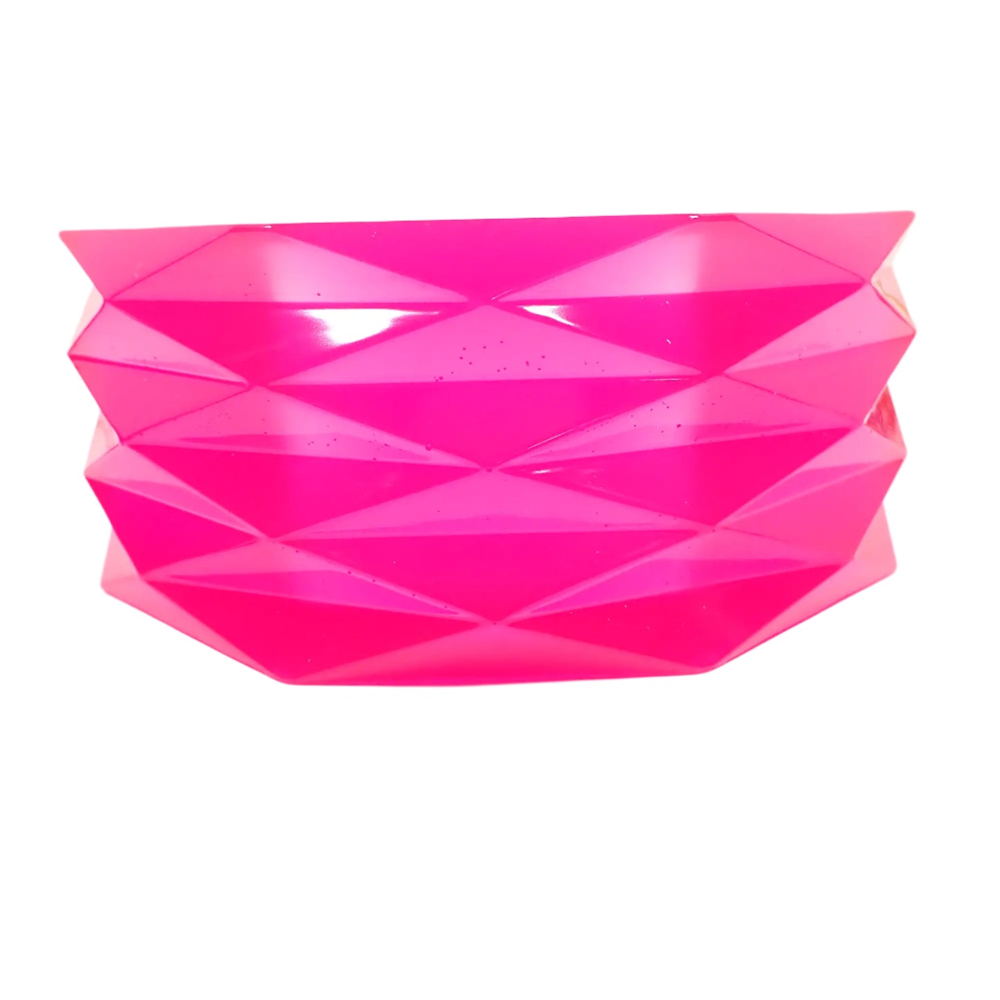 Side view of the handmade large neon pink resin geometric bowl showing the rows of faceted diamond shapes going all the way around it.