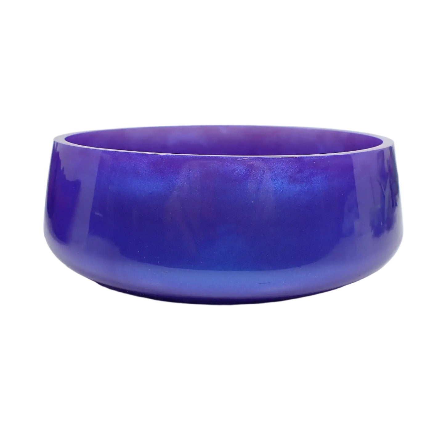 Side view of the large handmade resin decorative bowl. The resin is shiny and opaque in an iridescent purple color that has flashes of blue when the light hits it for an almost color shift like appearance. Great to add to your home decor for a pop of color.