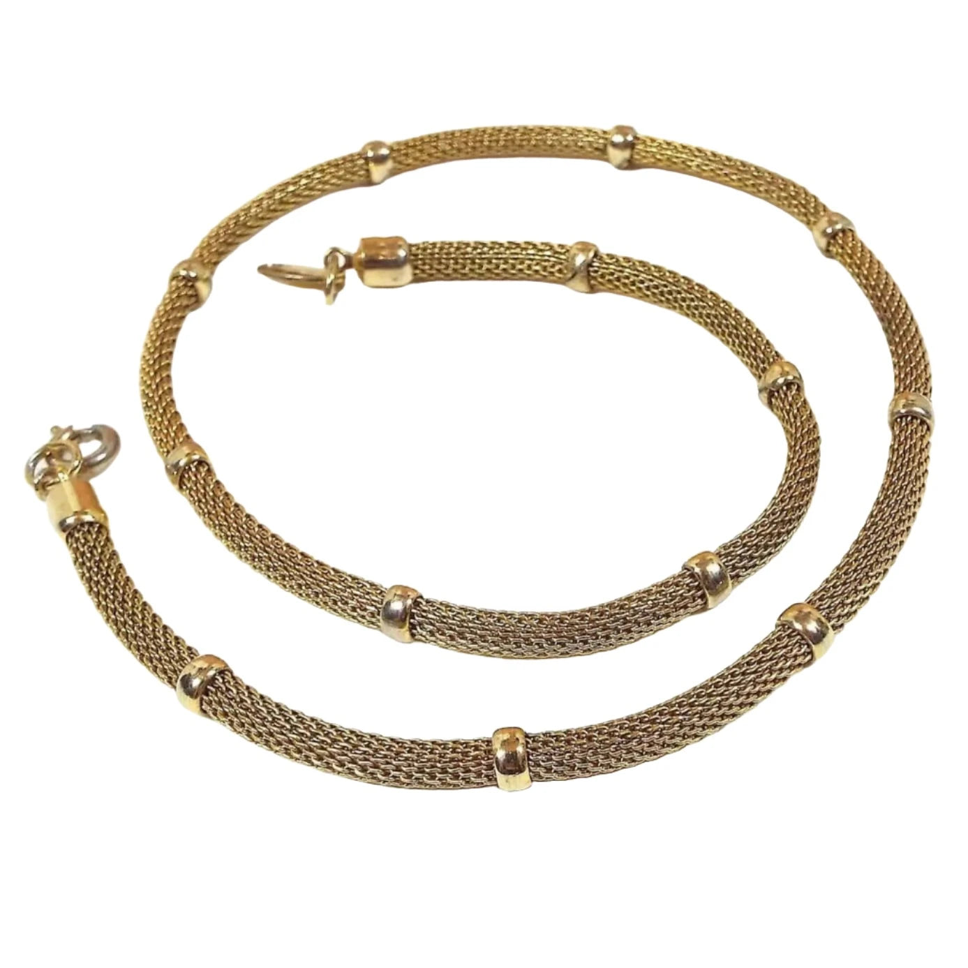 Chain is gold in color with round mesh between permanently affixed round gold color beads. It has a spring ring round type clasp.