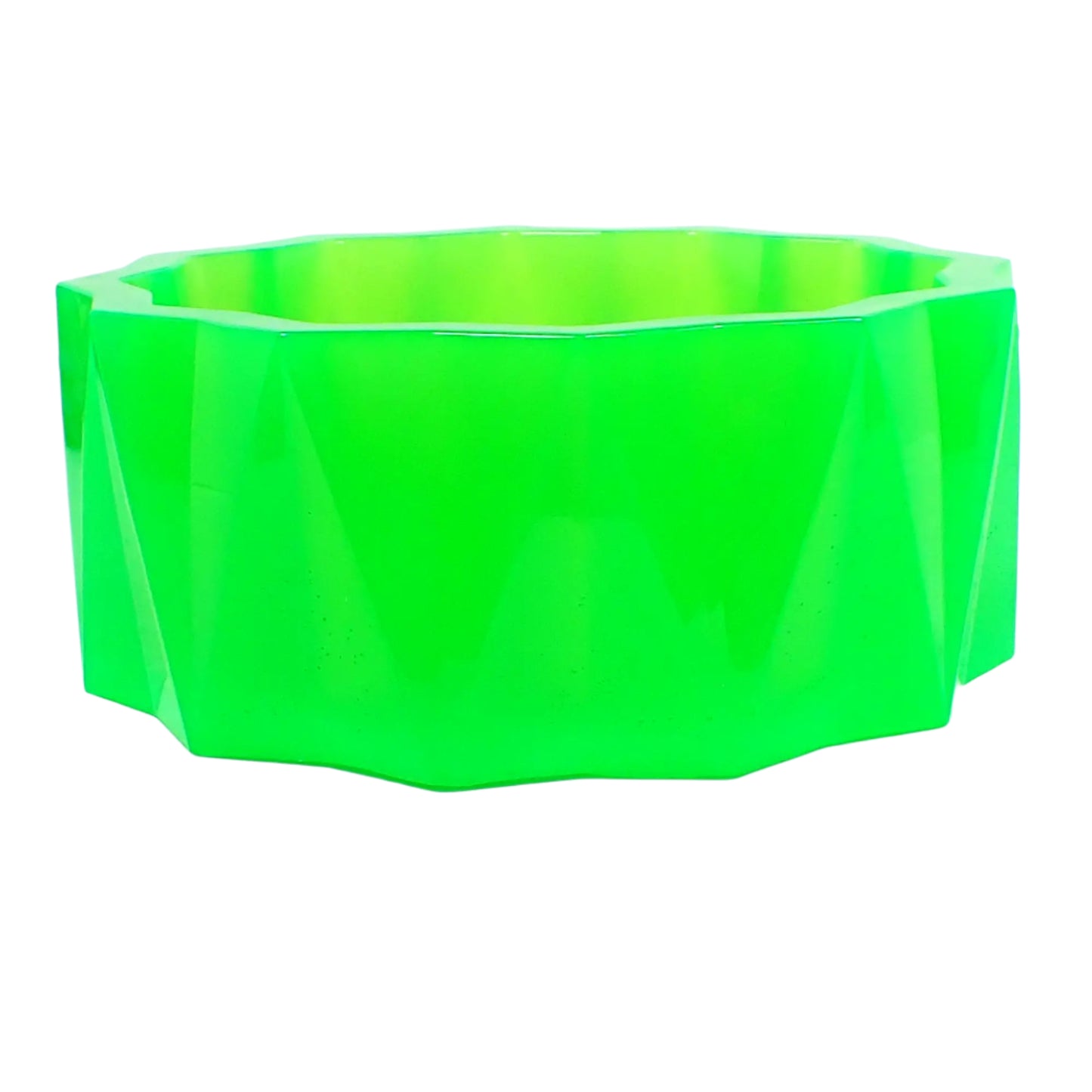 Side view of the large handmade neon green resin bowl showing the faceted triangle design around the outside. The triangles are long and are pointing in alternating directions.