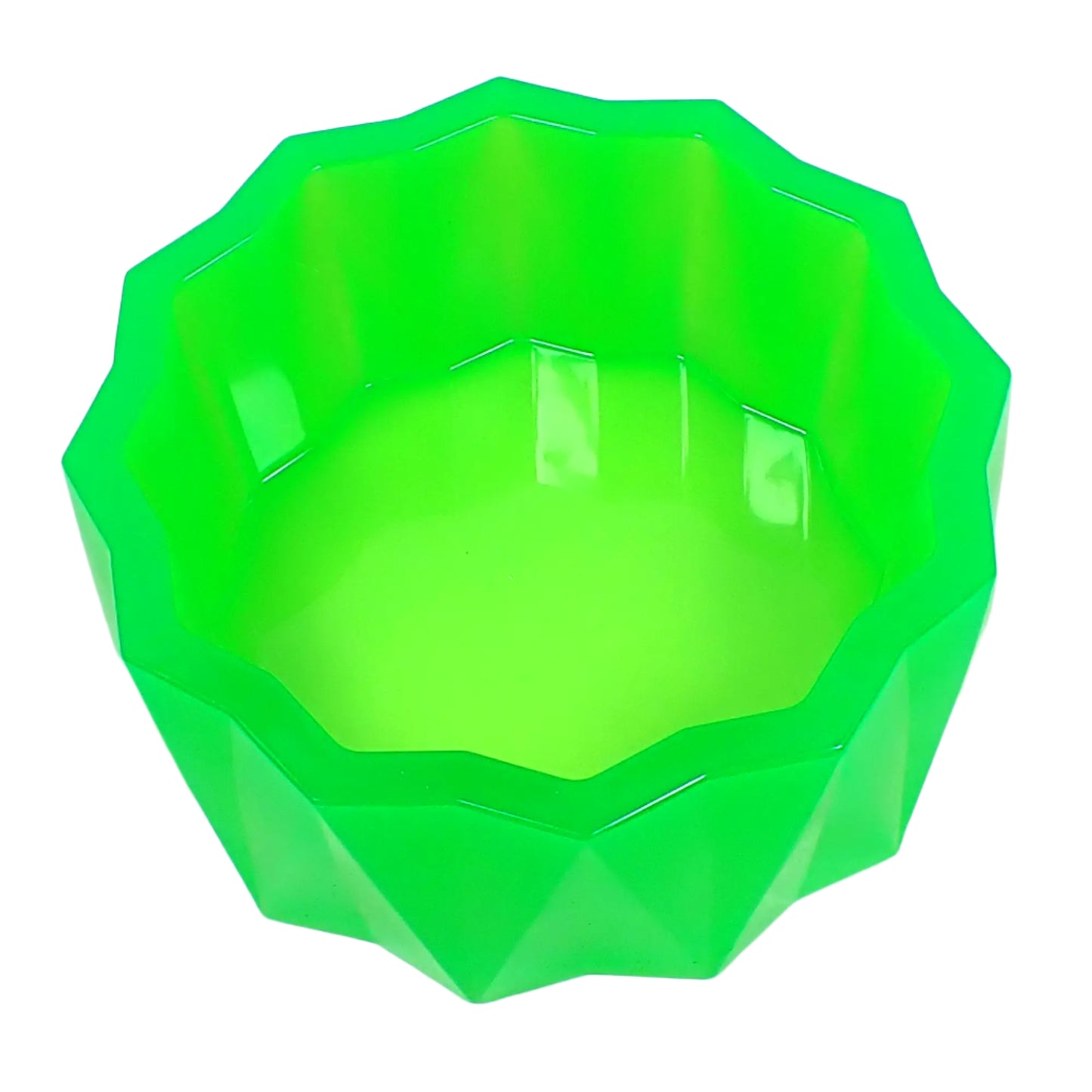 Top view of the large handmade neon green resin faceted bowl showing the inside area where items could be placed. The inside is shiny and smooth. The top edge is flat and smooth and shaped like a faceted sun.