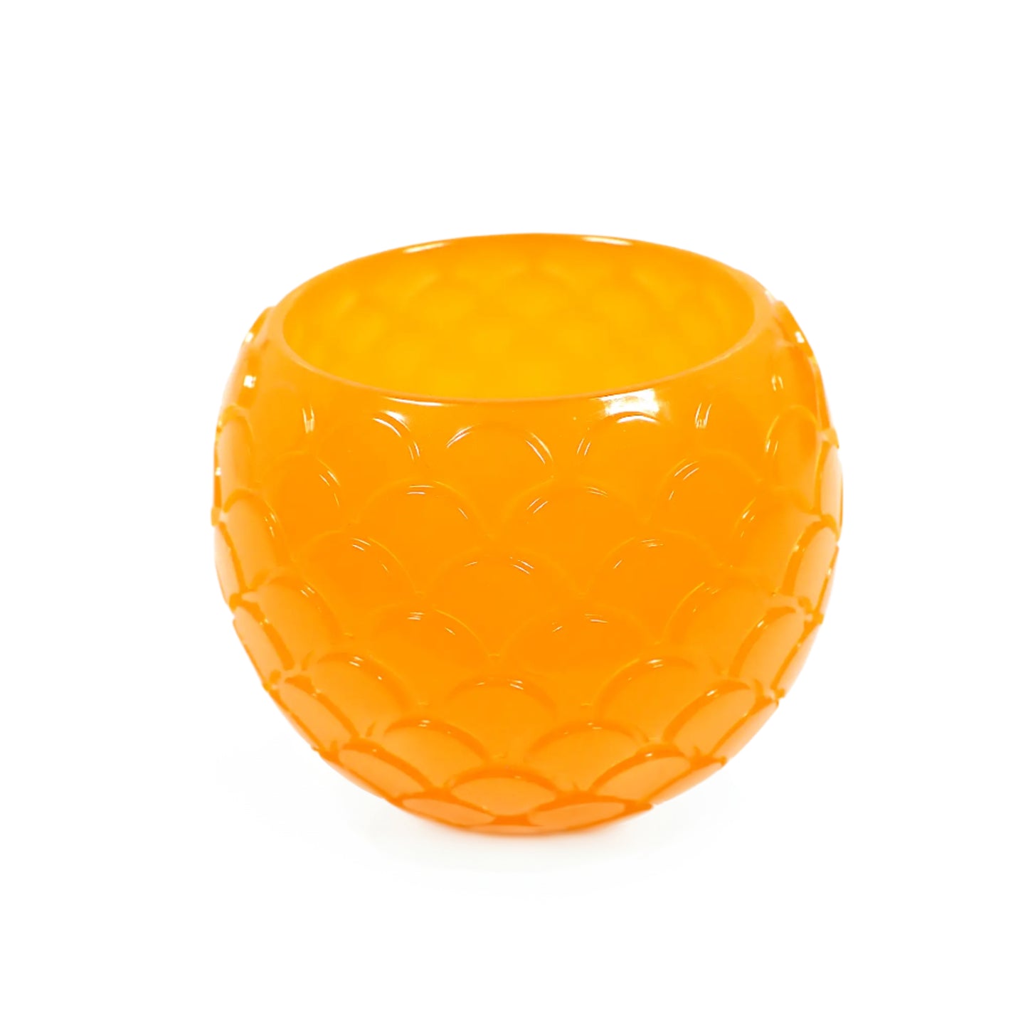Angled view of the handmade neon orange resin decorative bowl. It is round with a tapered bottom and has a raised scale design all around the outside of it. The resin is shiny and semi translucent in a neon orange color. Great as a small succulent planter pot or just to add to your home decor.