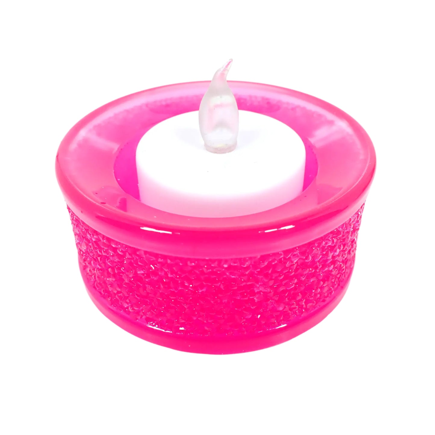 Image of the handmade bright neon pink resin tealight candle holder with a flameless LED tea light candle displayed in it.