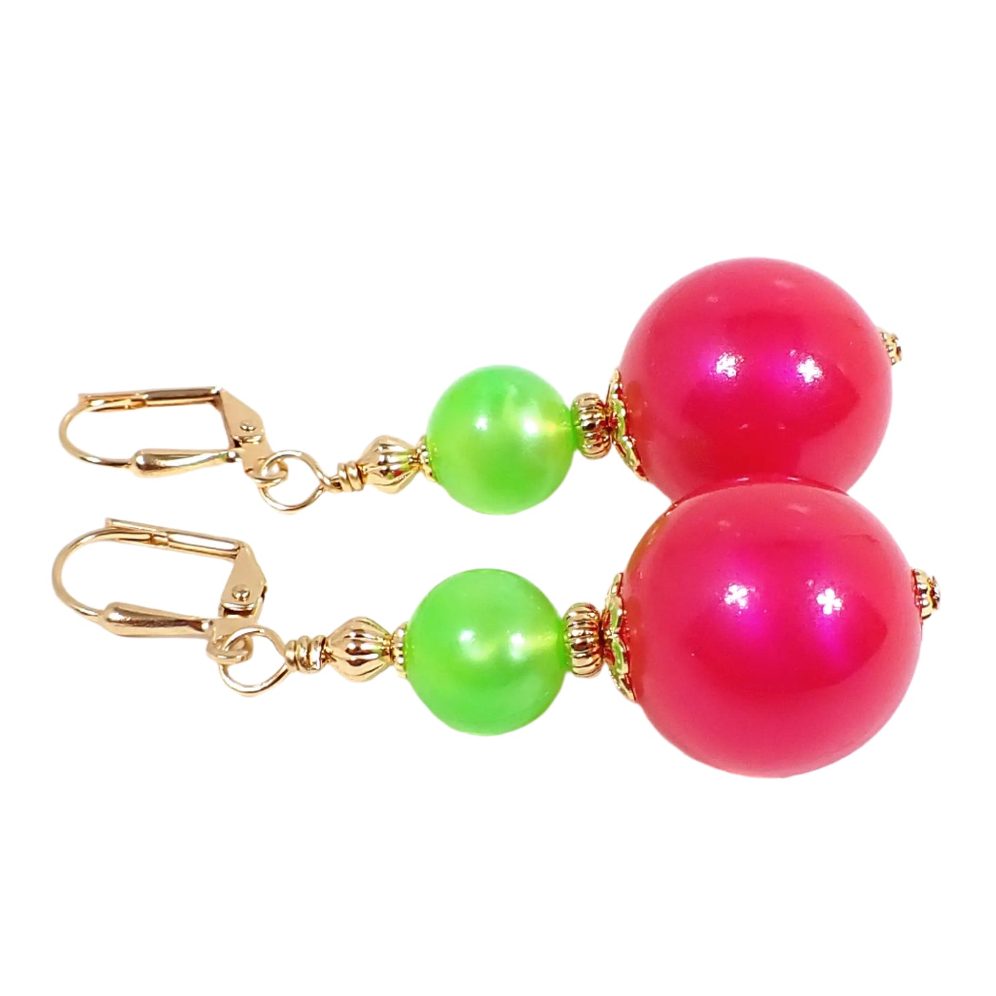 Side view of the handmade beaded gumball drop earrings. The metal is gold tone in color. There is a round pearly neon green bead at the top and a larger pearly iridescent neon pink bead at the bottom. Both beads are gumball sphere shaped and are vintage new old stock German acrylic beads.