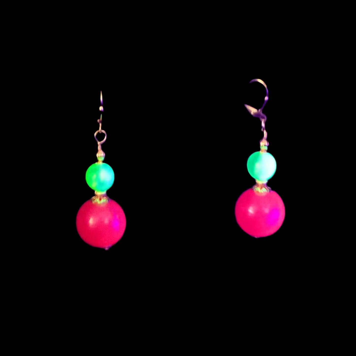 Image of the neon pink and green beaded round gumball earrings showing that they are fluorescent and glow bright pink and green under UV light.