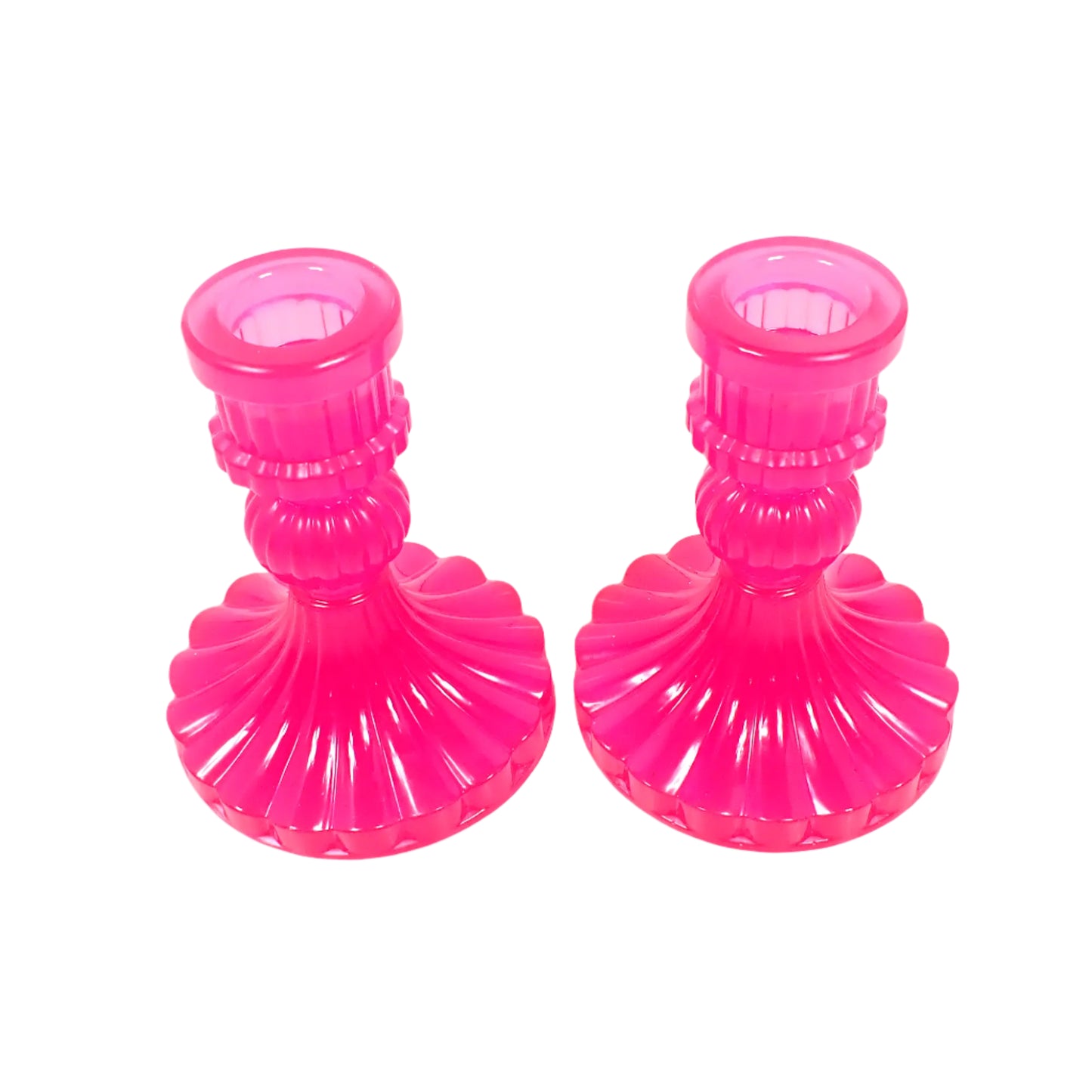Angled top view of the handmade neon pink resin candle holders showing the top opening where the taper candlesticks would go. The resin is shiny and semi translucent in a bright pink color.