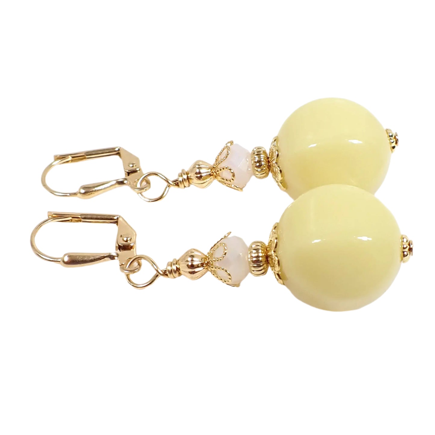 Side view of the handmade beaded nugget earrings. This image shows them with the lever back pierced components at the top though other options are available. The faceted glass beads at the top are opaque. There are vintage German acrylic beads at the bottom in a pastel yellow color.