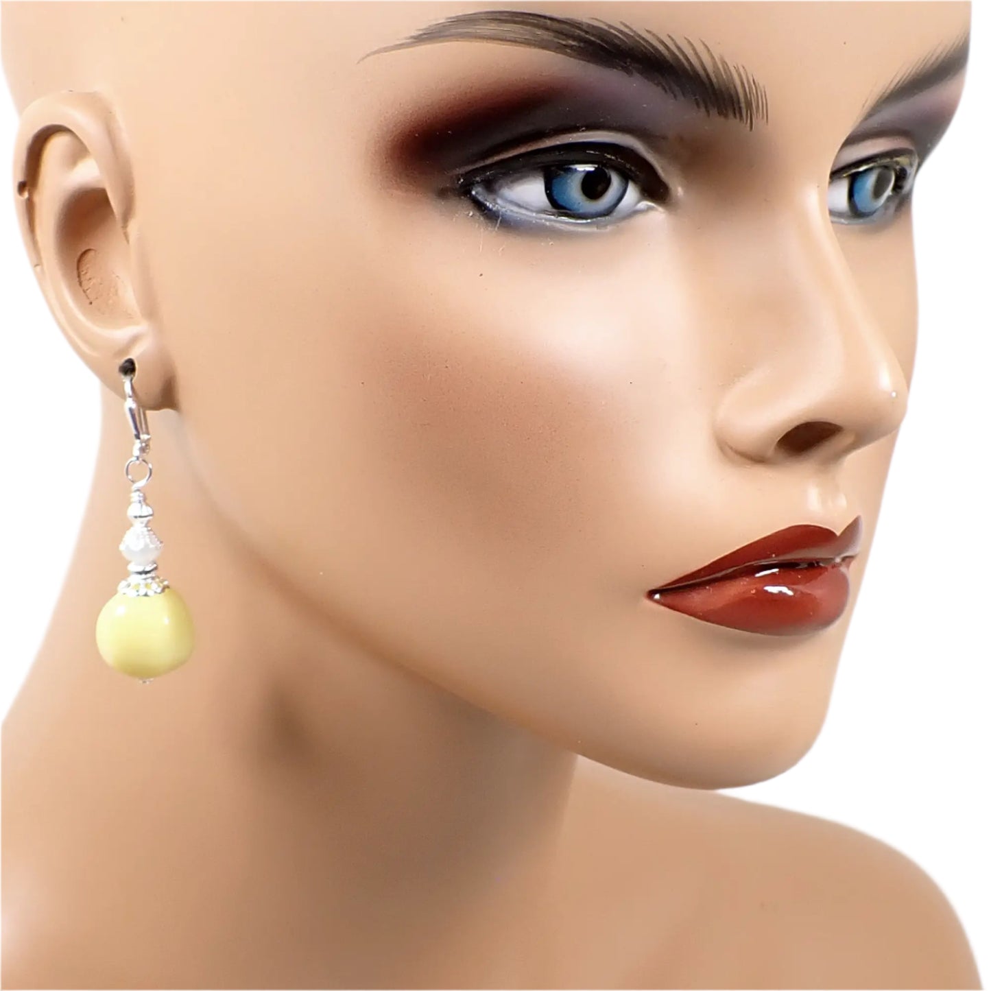 Image of one of the handmade pastel yellow nugget earrings on a full sized mannequin to show how they would look worn and to give an indication of size.