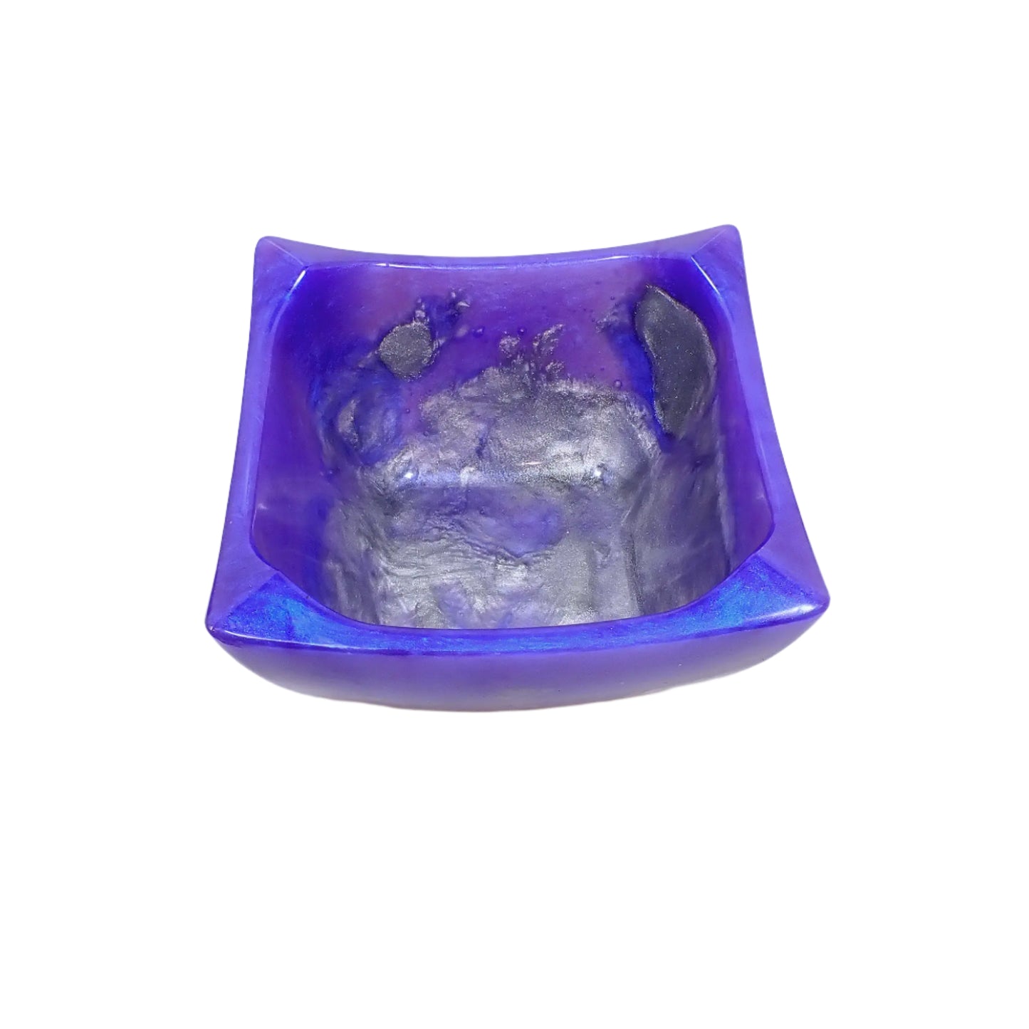 Angled top view of the handmade Retro Atomic style square decorative bowl showing more of the metallic silver color resin on the inside of the bowl. The rest of the bowl has iridescent areas of purple and blue depending on how the light is hitting it.