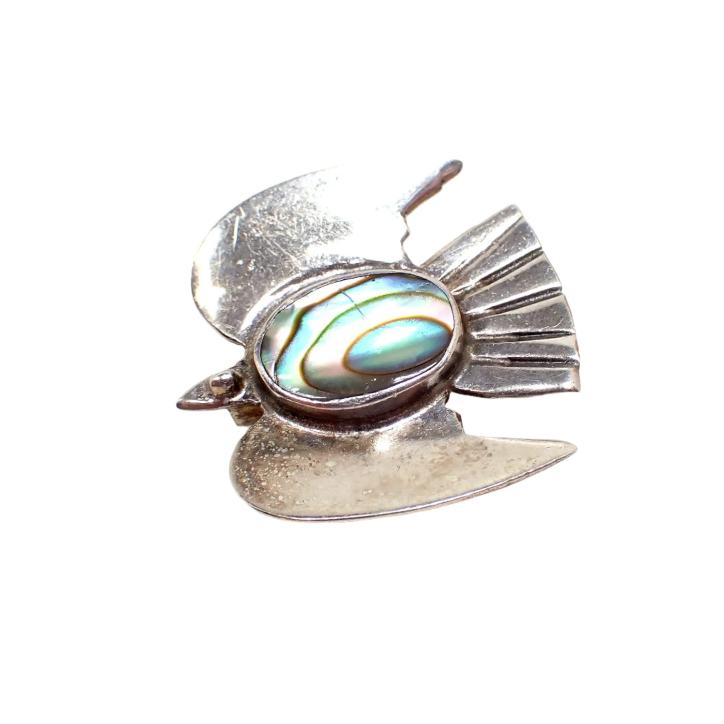 Angled top view of the small bird brooch showing the iridescent colors of the abalone cab.