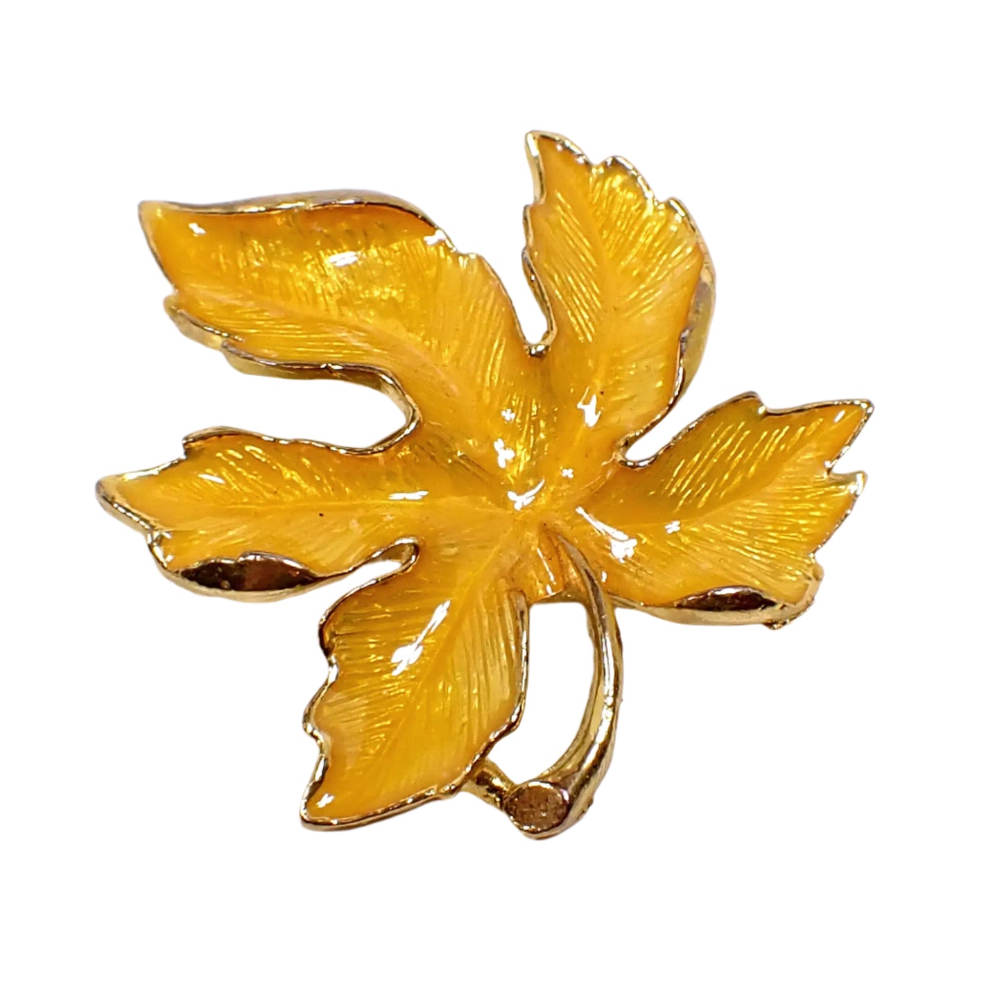 Front view of the vintage enameled leaf brooch. It's shaped like a maple leaf and has gold tone color metal with bright yellow enamel on the front.