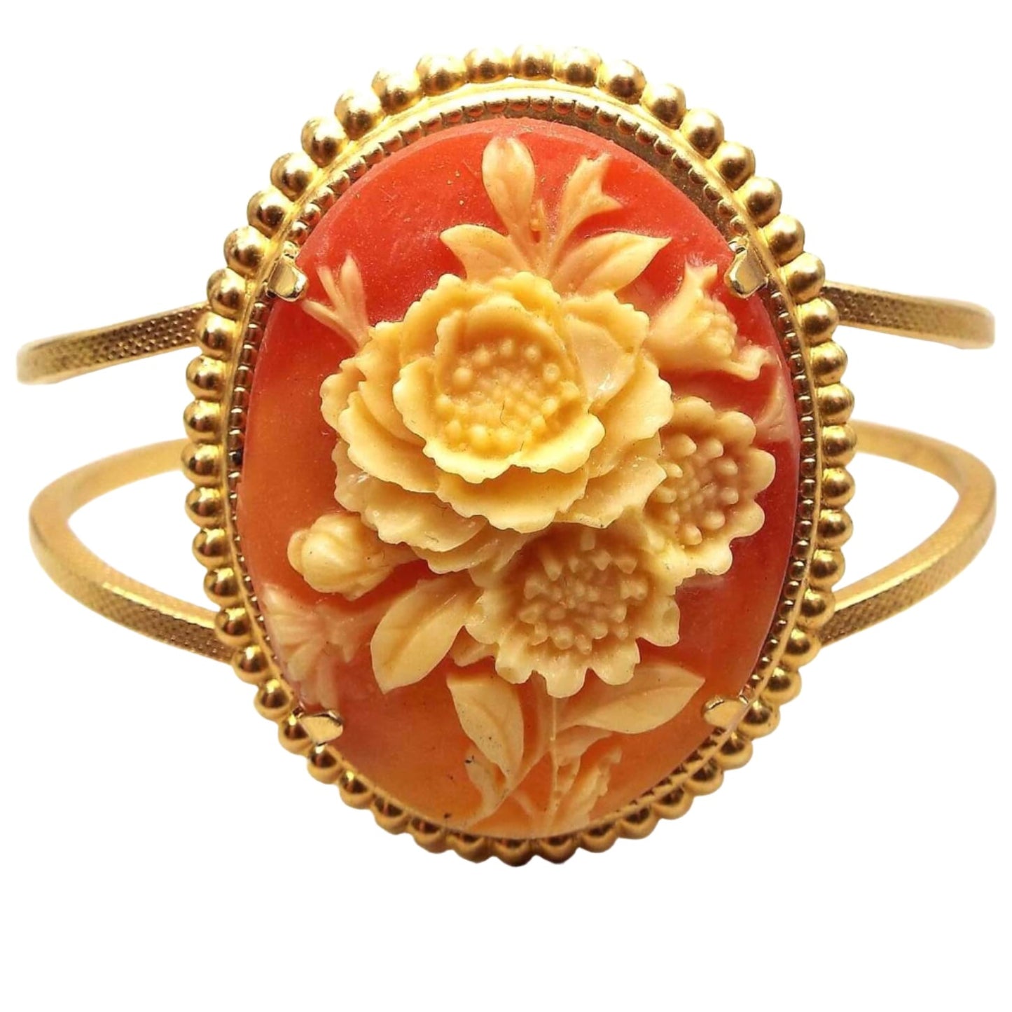 Front view of the retro vintage floral cameo hinged bangle bracelet. The metal is gold tone in color. The front has a large oval with three flowers in the middle in yellow tones. The background of the plastic cameo is shades of orange.