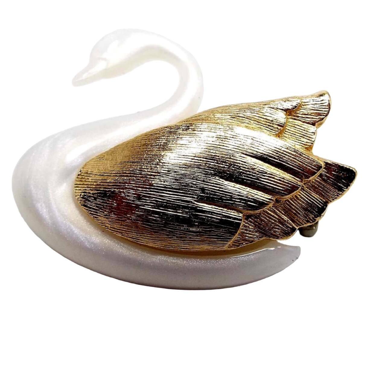 Front view of the retro vintage Avon swan brooch pin. It is pearly white in color and has gold tone color textured metal wings.