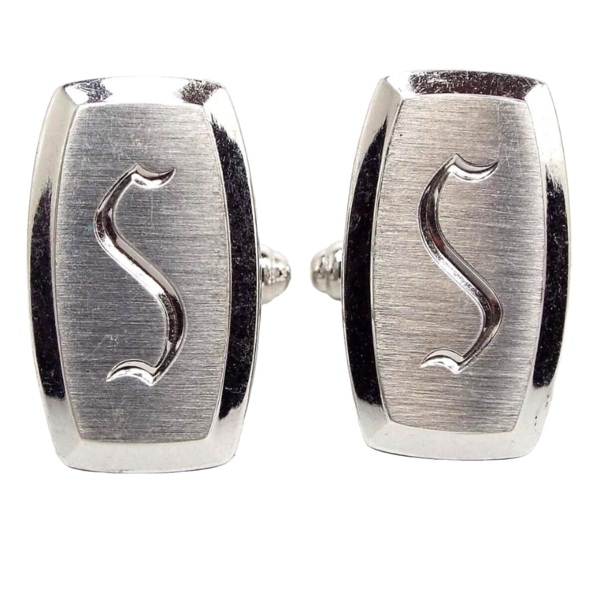 Front view of the Mid Century vintage Hickok initial cufflinks. They are silver tone in color and have a rounded edge rectangle shape. The front has matte brushed metal with the letter S engraved on in the middle.
