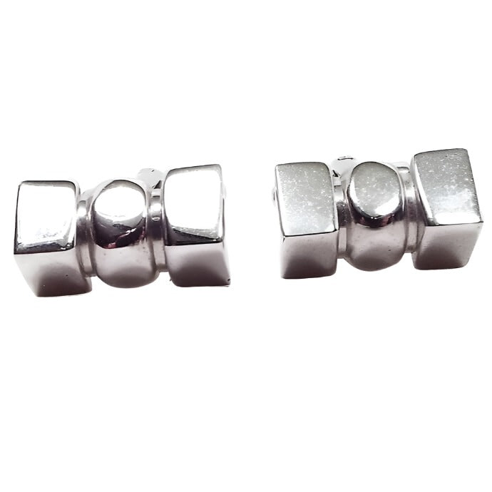 Front view of the Shields Mid Century vintage cufflinks. They are silver tone in color and have a 3D style shape with rectangles on each side and an oval in the middle.