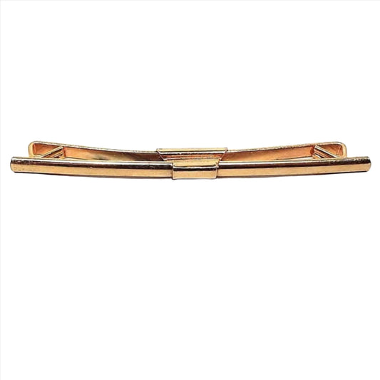 Front view of the 1940's long vintage collar clip. It is gold tone in color with a slightly curved bar on the front.