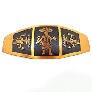 Front view of the Mid Century vintage Kachina belt buckle. It is a large curved design with three sections that have Kachina representations in them. Each has a black background.