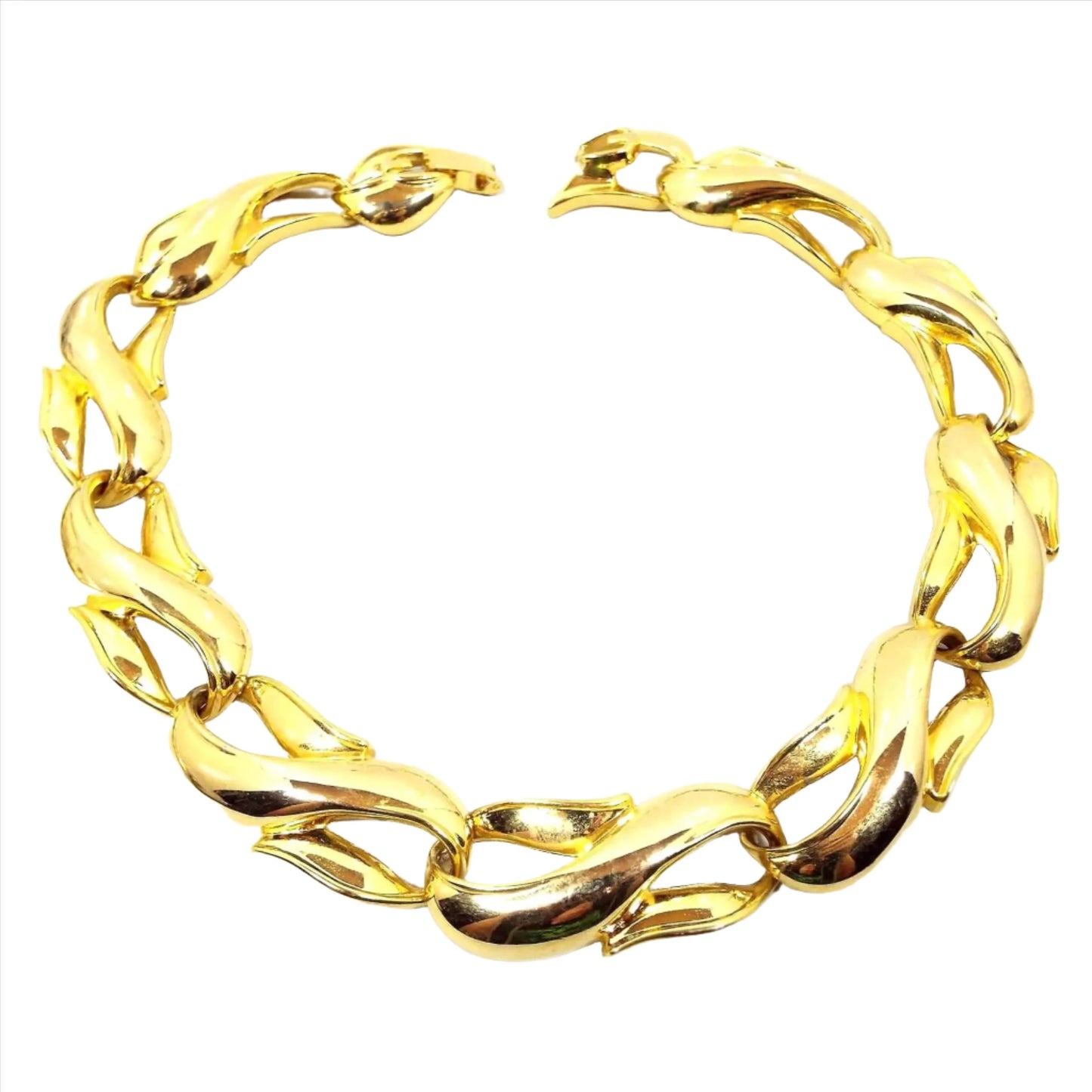 Front view of the retro vintage link necklace. It is gold tone in color with large wide sideways S shaped links. There is a snap lock clasp on the end.