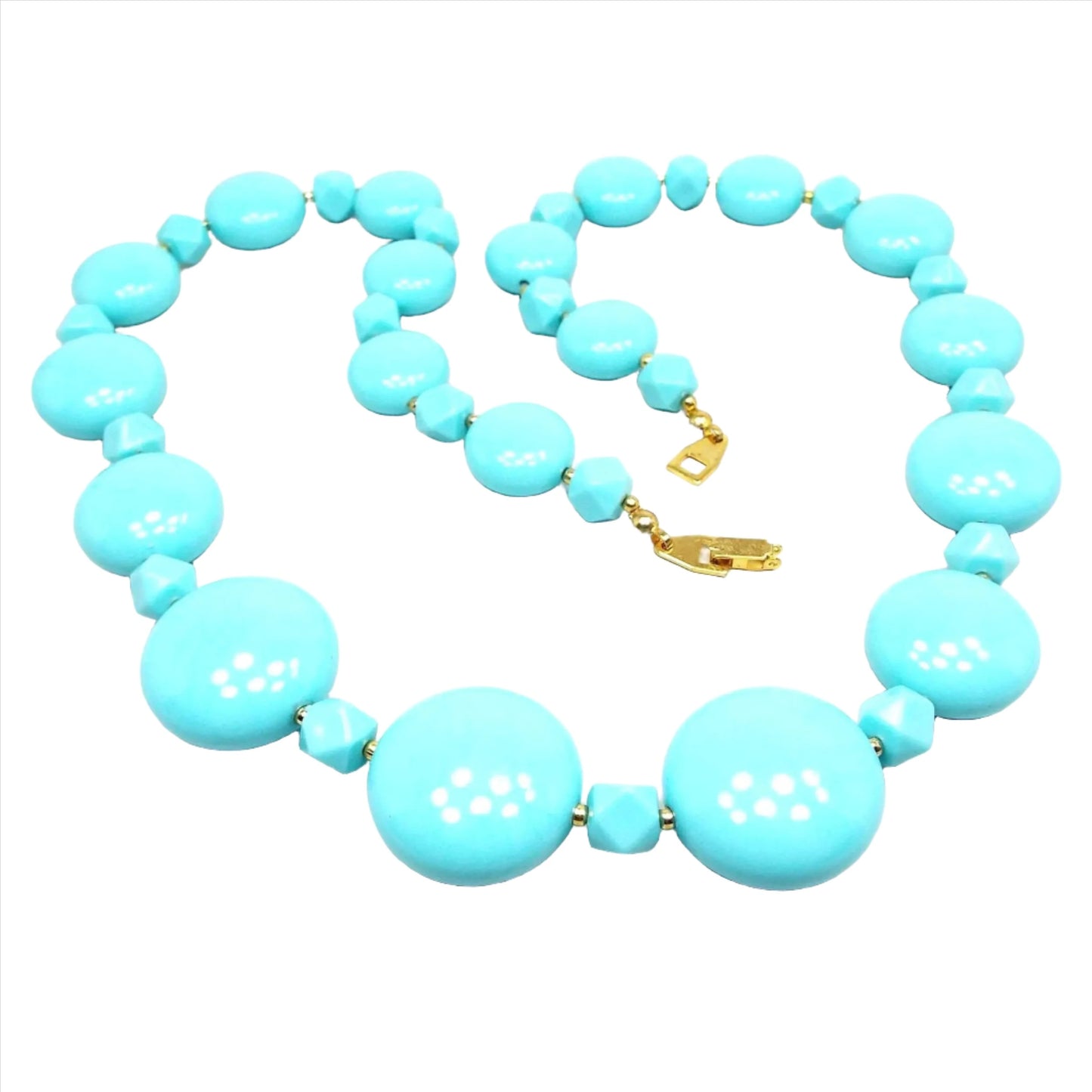 Front view of the retro vintage lucite beaded necklace. The beads are aqua blue in color. There is a gold tone plated snap lock clasp at the end. The beads are flat round pillow shaped with faceted beads in between.
