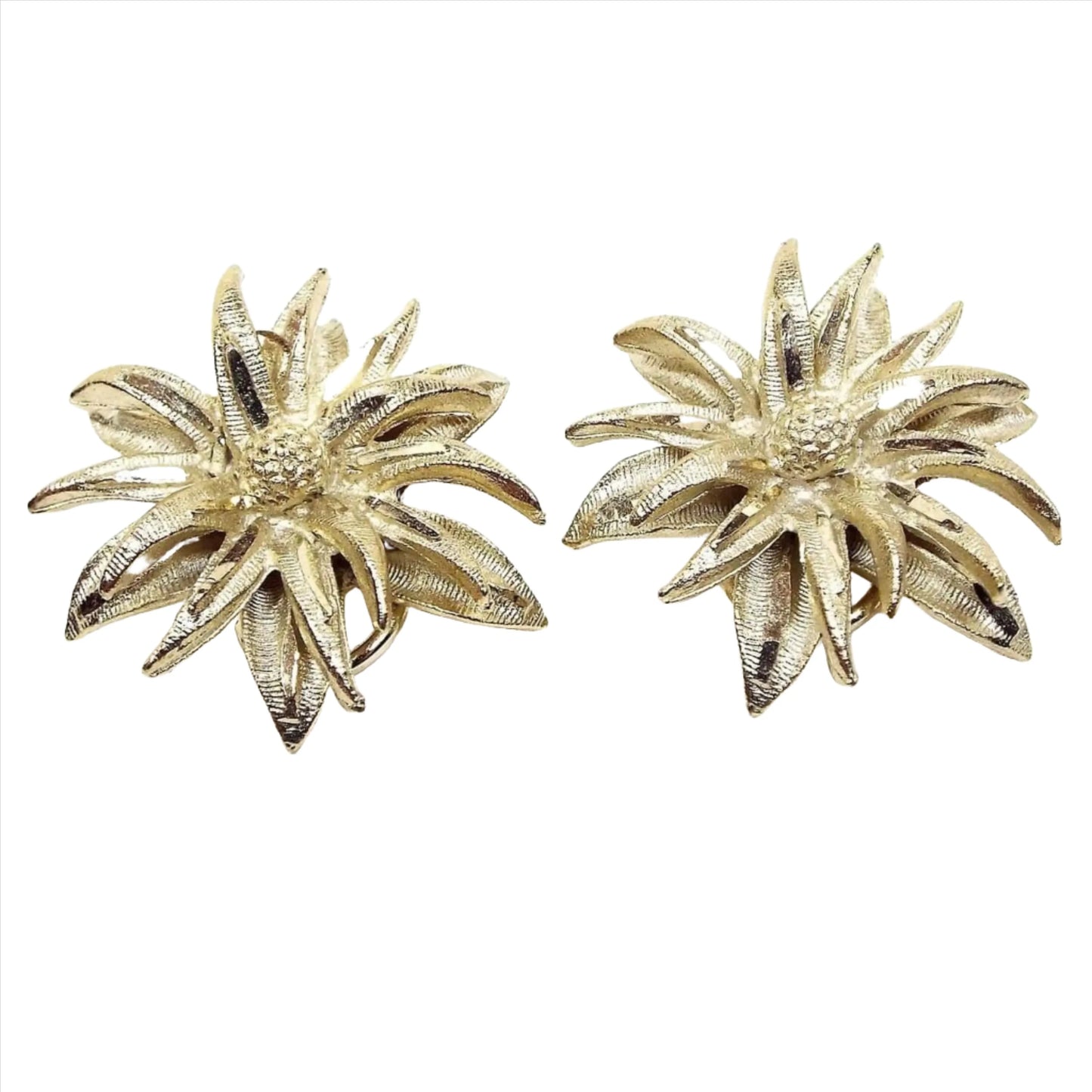 Front view of the retro vintage BSK floral earrings. They are textured gold tone in color with lots of long tapered style petals making up the flower design.