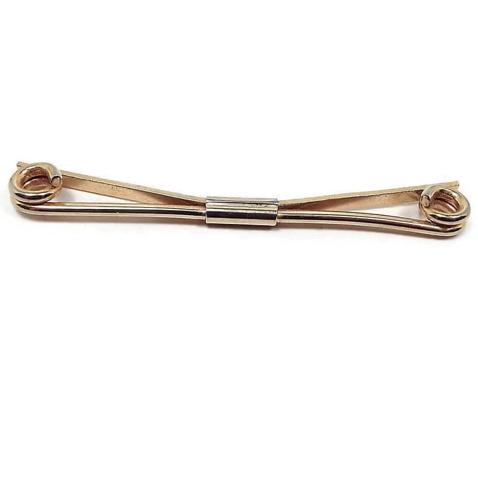 Front view of the 1960's long spiral end collar clip. It is gold tone in color with coil ends.