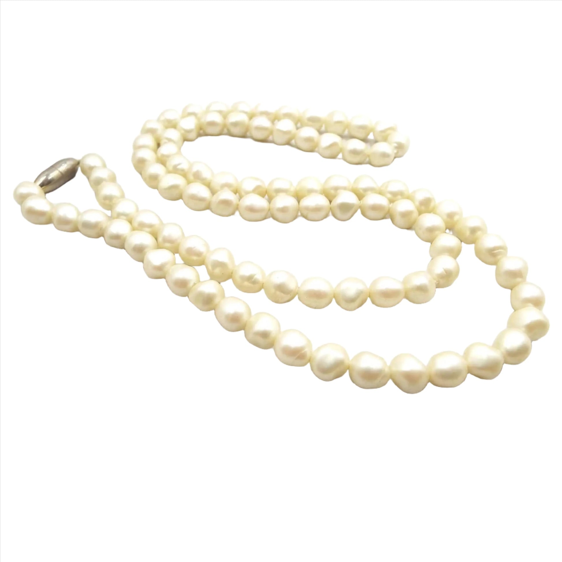 Angled view of the retro vintage baroque shaped faux pearl beaded necklace. The beads are off white in color. There is a screw barrel clasp at the end.