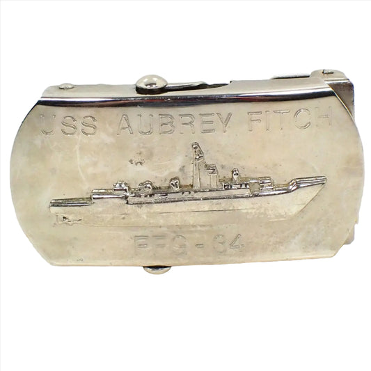 Front view of the retro vintage Aubrey Fitch belt buckle. It is silver tone in color and shows an area on the side where the slide holds the belt in place after you slide it through the buckle. The front has a depiction of the ship and is engraved USS Aubrey Fitch at the top and FFG - 34 at the bottom.