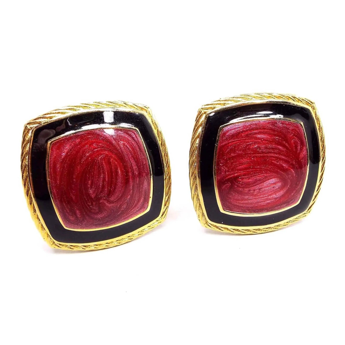 Front view of the retro vintage enameled clip on earrings. The metal is gold tone in color and has a twisted like edge around the square earrings. In the middle is pearly dark pink enamel with black enamel around the edge of it.