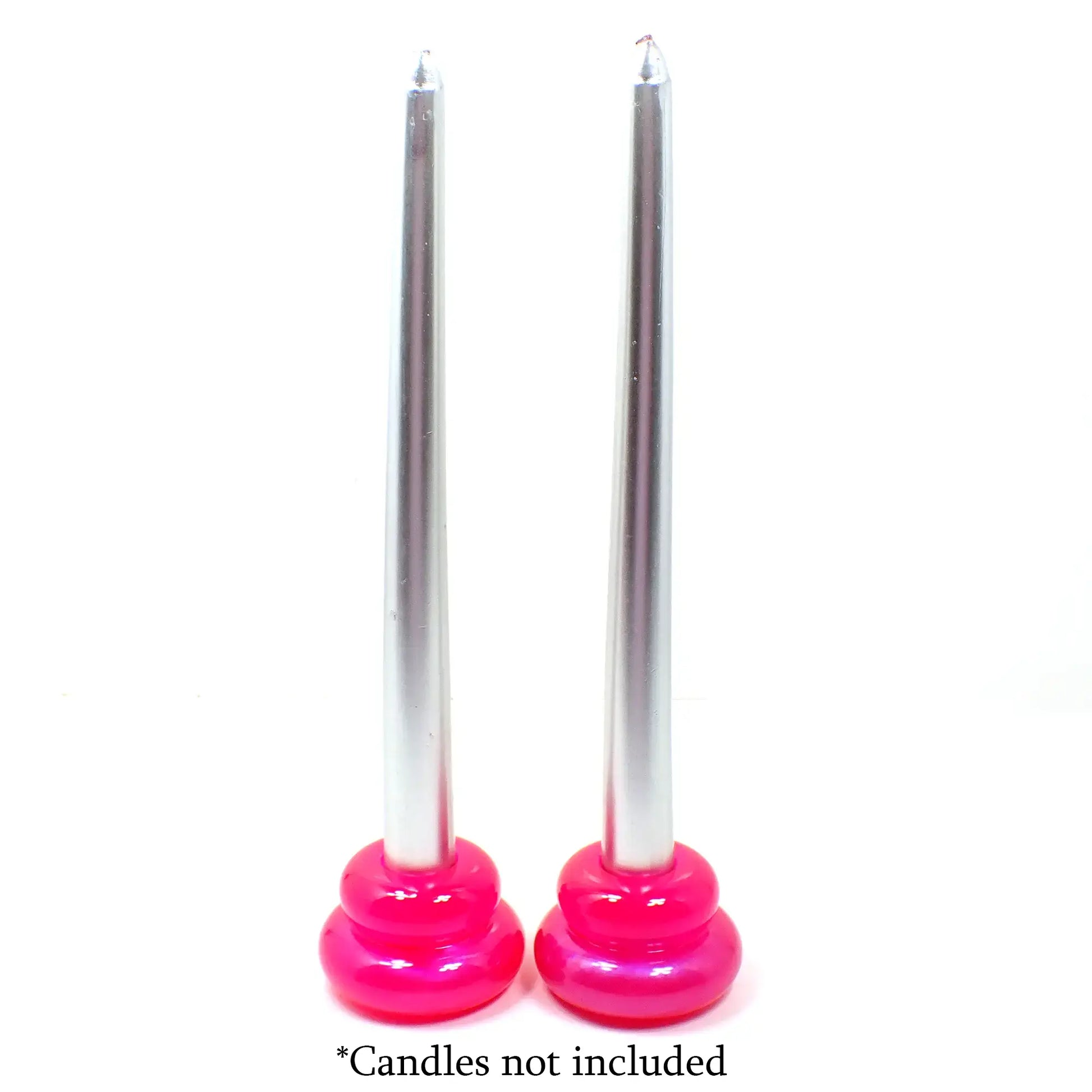 Photo showing how the handmade puffy double ring candlestick holders look with candles in them. The candles being shown are silver in color and the candlestick holders are bright pink. At the bottom are the words "Candles not included."