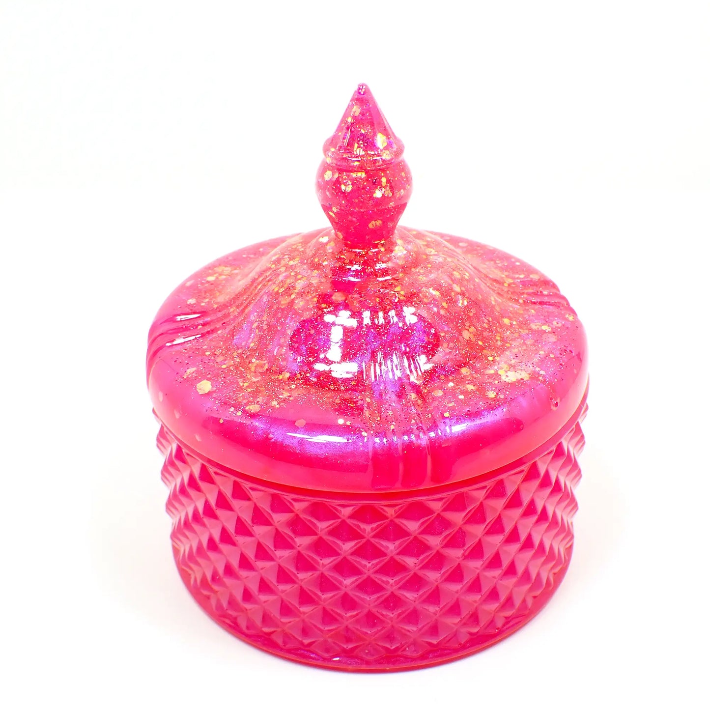Side view of the handmade large trinket candy dish. It has pearly pink resin with chunky iridescent glitter on the lid. The bottom part is a bright pearly pink color.