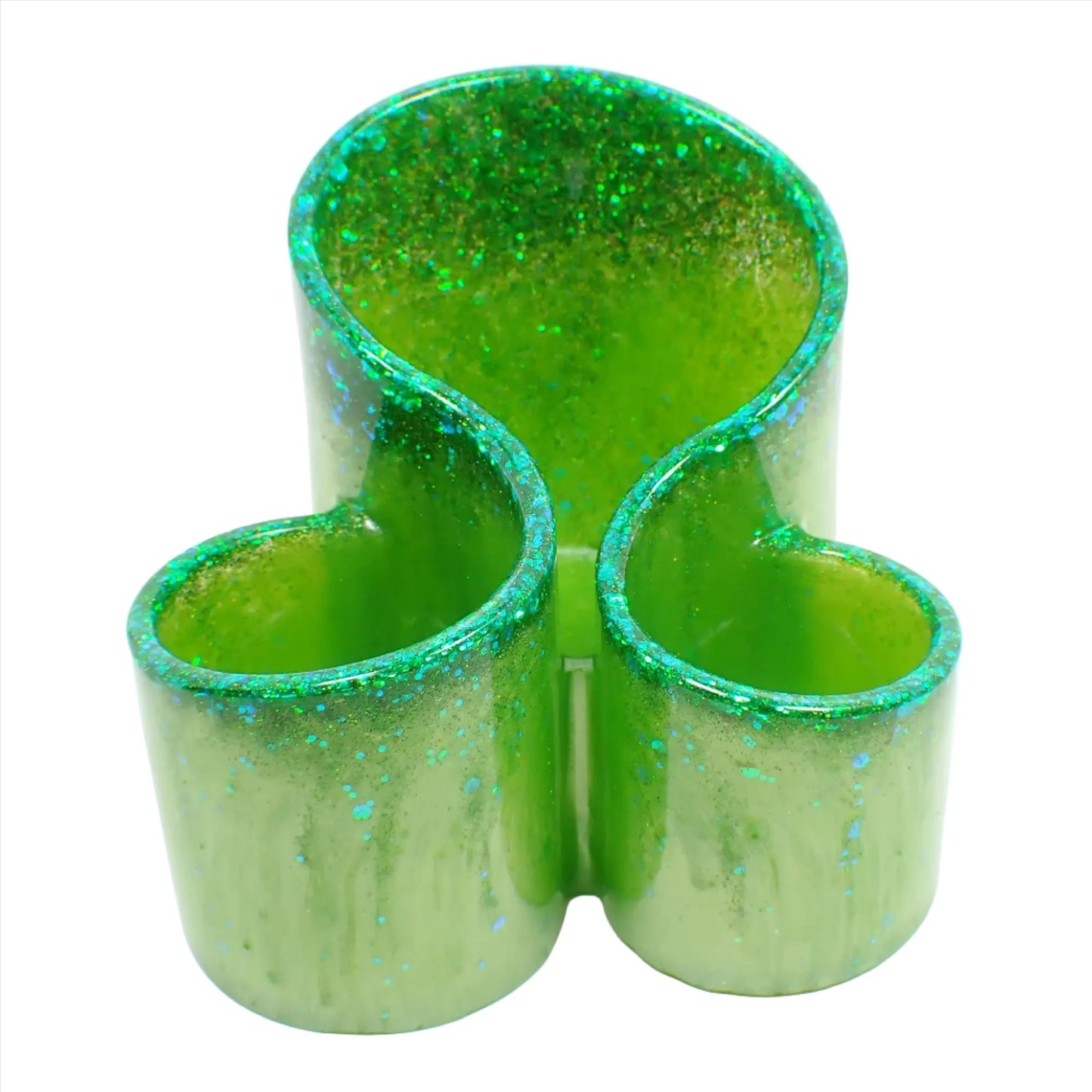 Front view of the handmade resin makeup brush holder. It has lime green resin with iridescent glitter at the top. There are three round areas to hold the brushes with the back having the tallest side.