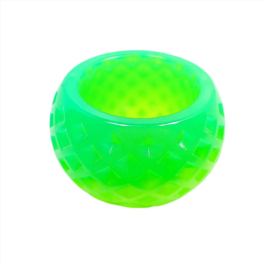 Side view of the small handmade resin succulent pot. It is round shaped the an indented diamond shape pattern design all the way around it. There is bright green at the top and lighter bright green at the bottom.