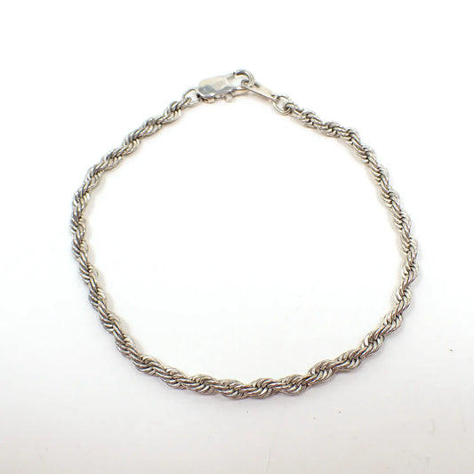 Top view of the retro vintage twisted chain rope chain bracelet. It is silver tone in color and has a lobster claw clasp at the end.
