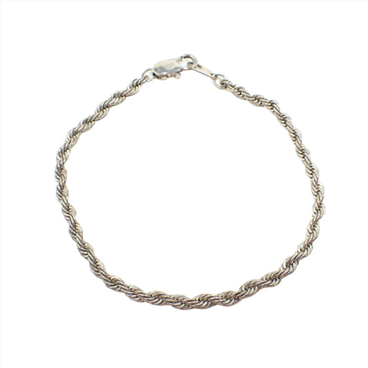Top view of the retro vintage twisted chain rope chain bracelet. It is silver tone in color and has a lobster claw clasp at the end.