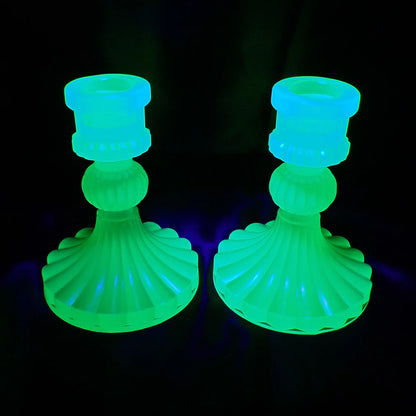 Photo showing how the handmade neon green resin vintage style candlestick holders fluoresce bright green under a UV light.