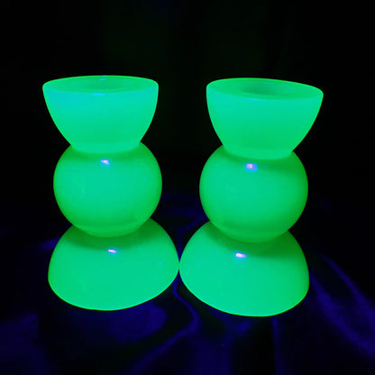 Photo showing how the neon green handmade resin geometric candlestick holders fluorescent bright green under a UV light.