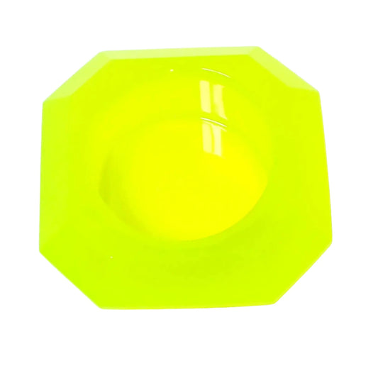 Top view of the faceted octagon handmade decorative pot. It is bright neon yellow in color with a tint of bright green. There is a round area in the middle for planting small succulents or putting tiny items in.