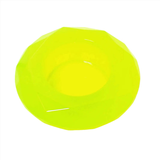 Top view of the handmade faceted round small decorative pot. It is bright neon yellow in color with a tint of bright green. There is a round opening in the middle for planting small succulents or putting tiny trinkets.