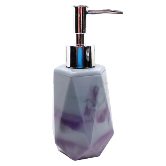 Side view of the handmade resin soap dispenser. It has a faceted shape with tapered top and flared bottom. The resin has marbled shades of purple and gray color. The pump showing in the photo is silver in color.