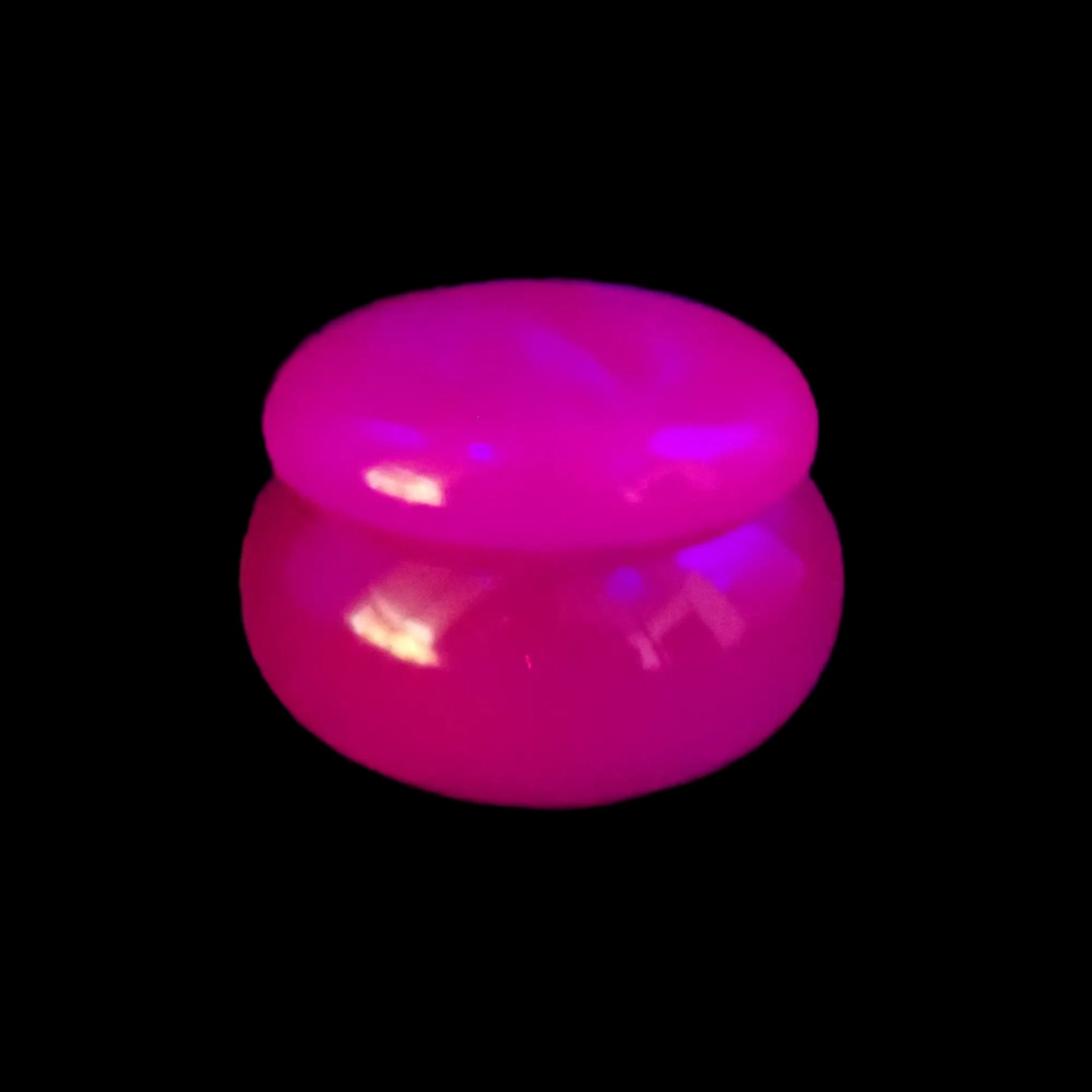 Photo showing how the neon purple in the small handmade resin trinket box glows under a UV fluorescent light.