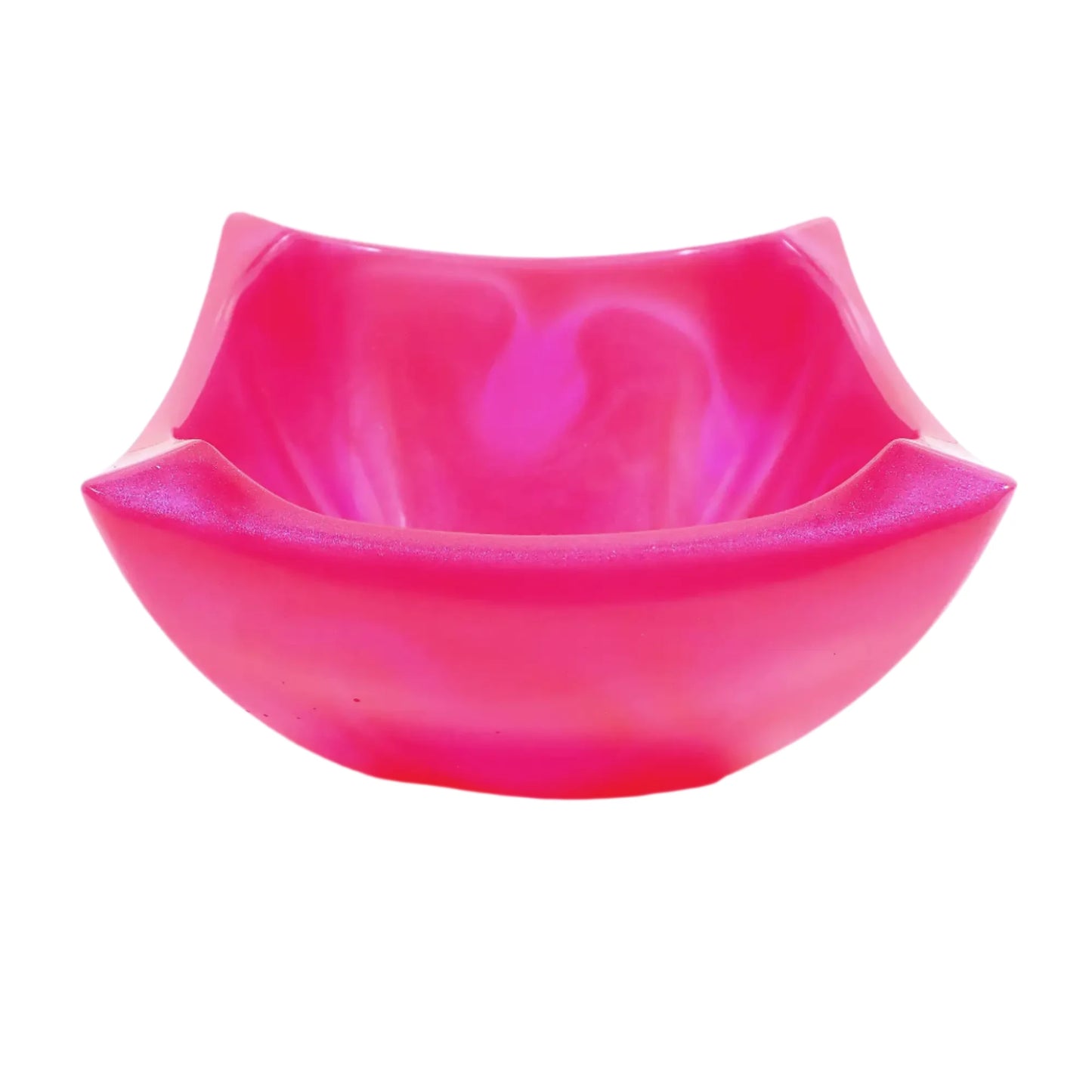 Angled view of the handmade decorative bowl. The resin is marbled in bright pearly pink with neon pink. The bowl is square shaped with angled pinched edges for a retro style appearance.