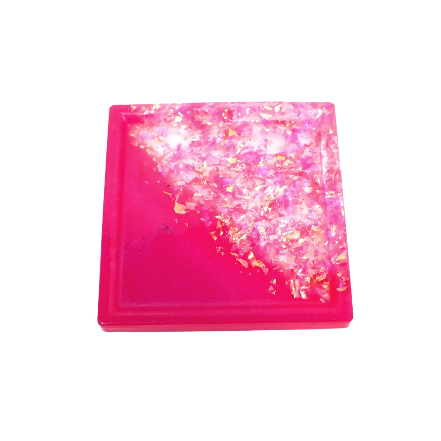 Top view of the small handmade resin trinket dish tray. It is square shaped with pearly bright pink resin on one diagonal side and has iridescent pink glitter flakes on the other side.