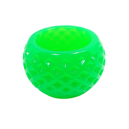 Side view of the handmade small decorative bowl. It has a rounded shape with an indented diamond pattern design. The color is a bright neon green. 